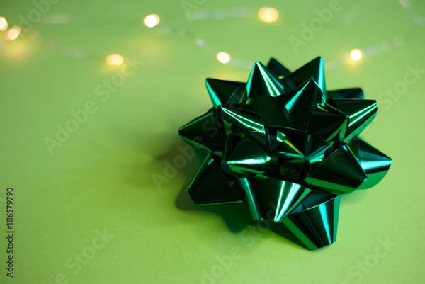 Obraz An Elegant Green Gift Bow beautifully placed on a Soft and Light Background that enhances its charm