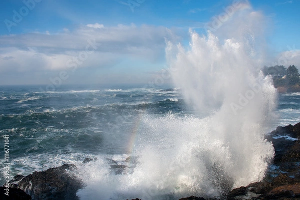 Fototapeta Water spout between rocks, waves crashing on rocky shores