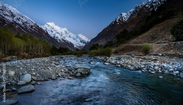 Fototapeta Twilight stream winds through rocky silence, cold water threading between midnight shadows, echoing mountain's deep, unspoken stories.
