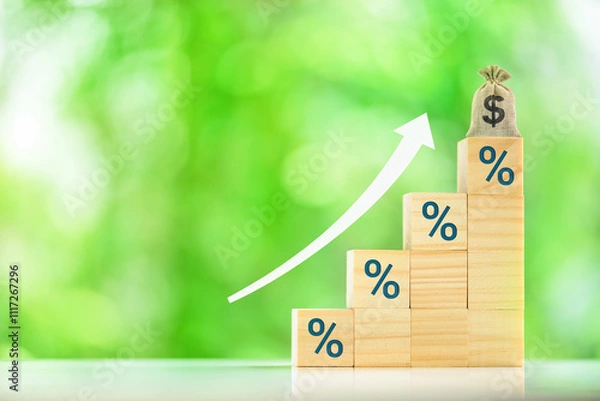 Fototapeta Financial growth, investment, increasing interest or lending rates : The wood blocks with "%" symbols stacked in a stair-like formation, along with the dollar sign money bag and upward-pointing arrow.