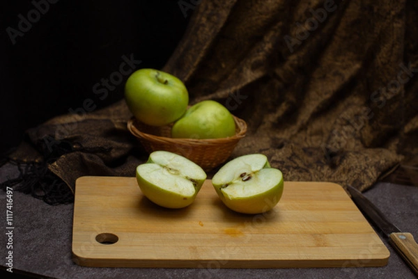 Fototapeta Green apples. Sliced green apples on the kitchen board