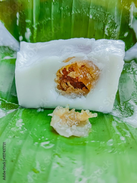 Fototapeta Steamed flour with coconut filling wrapped with banana leaf, Kanom sai sai.