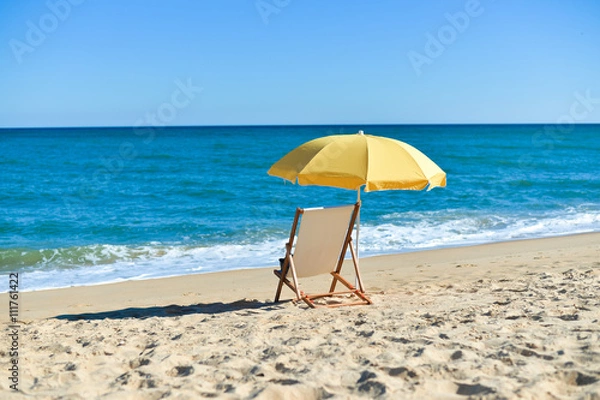 Fototapeta Back View Of Deckchair, Sun Lounger Under Umbrella On Sand Beach. 
