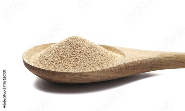 Fototapeta Dry yeast in wooden spoon isolated on white background, side view

