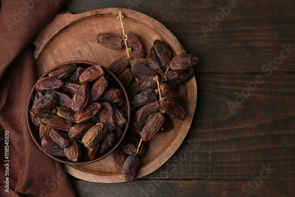 Fototapeta Tasty dried dates on wooden table, top view