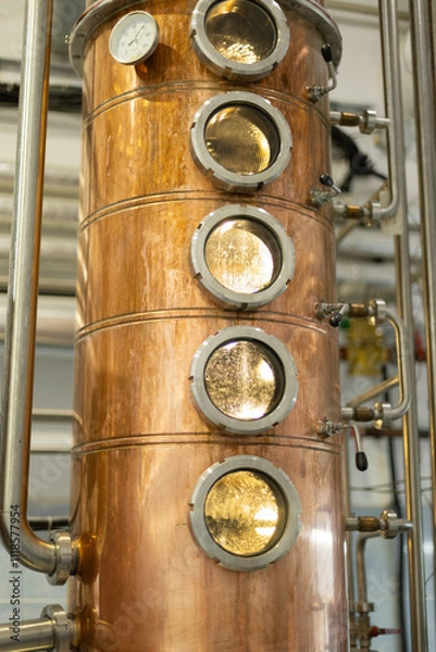 Obraz Distillate production process in copper distillation unit. Cpper vacuum still for distillation performed under reduced pressure for gin production.