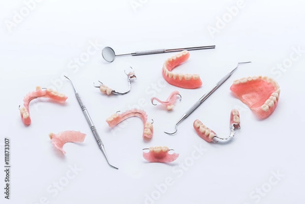 Obraz Set of dentures and dental tools on white background