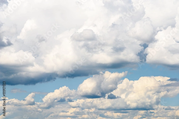 Fototapeta White Cumulus Clouds And Grey Storm Clouds Gathering On Blue Sky