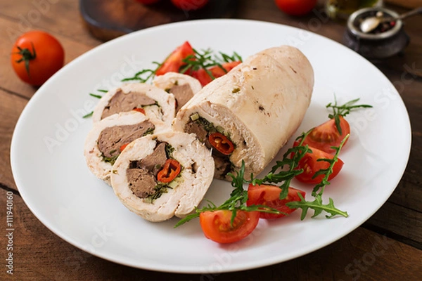 Fototapeta Diet baked chicken rolls stuffed liver, chili and herbs with a salad of tomatoes and arugula. Dietary menu. Proper nutrition.