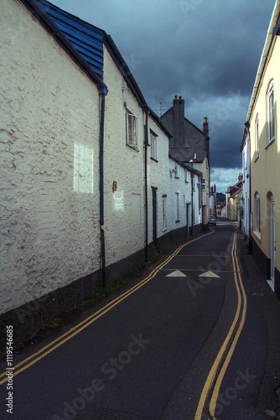 Fototapeta Narrow Street in Honiton, Devon, England, with Overcast Sky