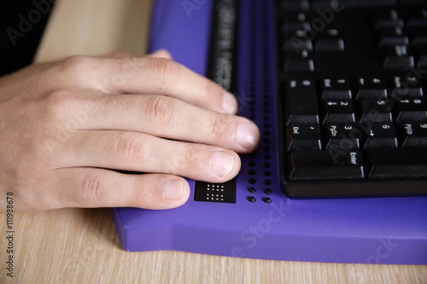 Fototapeta Blind person using computer with braille computer display