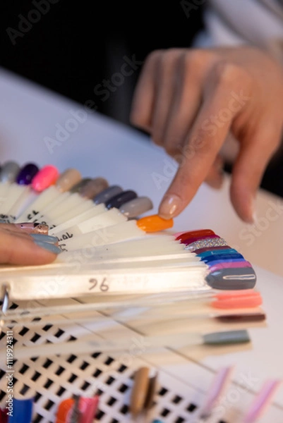 Obraz Nail choosing nail polish color from color palette in beauty salon, nail color palette