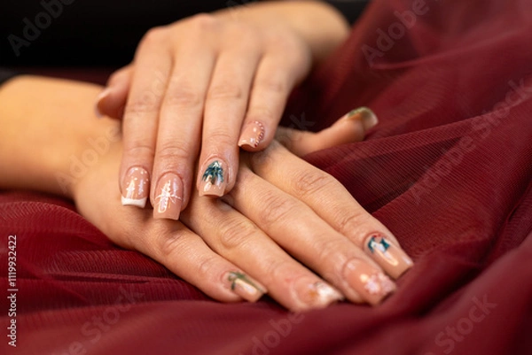 Obraz Christmas nail design, woman's hands with Christmas tree and candy cane design. Merry Christmas. Candy cane nails. Snowflake nails. Winter nails. Red fabric