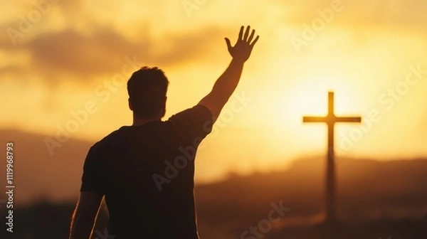 Fototapeta Man reaches for divine connection during a sunset near a cross on the horizon