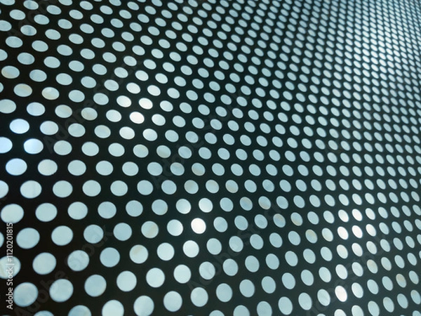 Fototapeta Abstract Perforated metal panel with circular holes forming a geometric and abstract pattern. Ideal for industrial, modern, or architectural designs with a clean and symmetrical aesthetic.