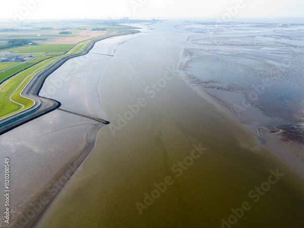 Fototapeta Aerial view of a tidal channel and mudflats near Termunterzijl, Groningen, The Netherlands