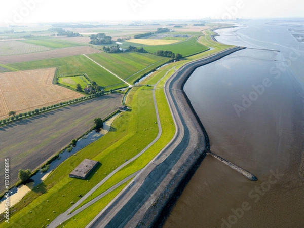 Fototapeta Aerial view of a tidal channel and mudflats near Termunterzijl, Groningen, The Netherlands