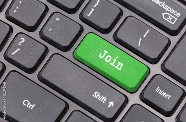 Fototapeta Computer keyboard closeup with "Join" text on green enter key