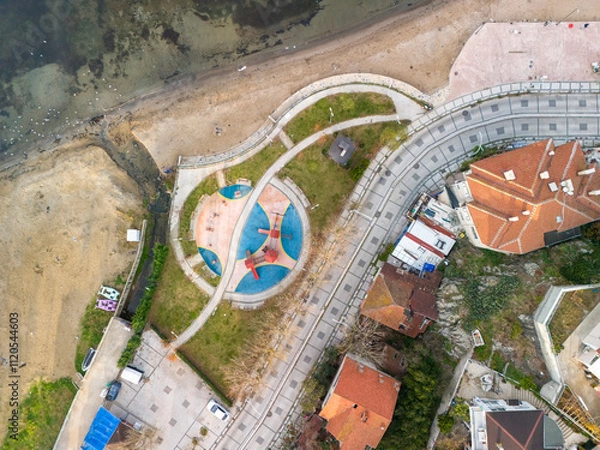 Fototapeta Istanbul Turkey Beykoz Poyrazkoy High-Angle View of Coastal Park and Residential Area. An aerial perspective of a coastal park with a playground, surrounded by walkways and residential buildings.