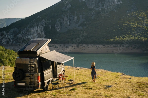 Obraz A camper van by a lake near a mountain, evoking tranquility and adventure in nature