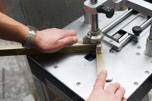 Fototapeta Craftsman working on frame in frameshop.