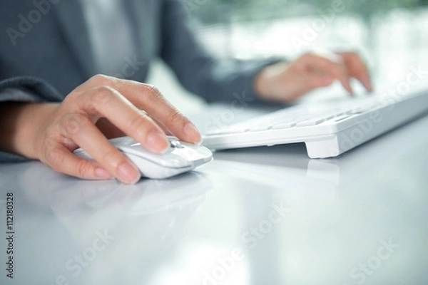 Fototapeta Female hand with computer mouse on table