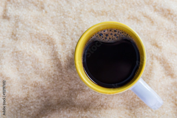 Fototapeta Coffee latte with a cup on sugar background.