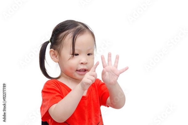 Obraz Little asian girl counting her finger over white