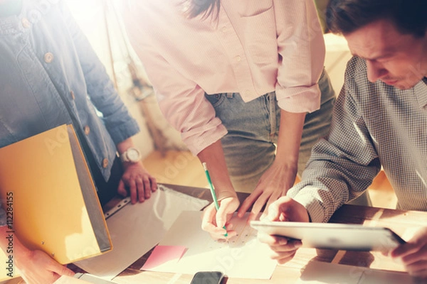 Obraz Team brainstorming. Tablet computer and paperwork on the table. Vintage effect 