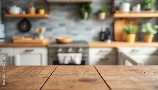 Fototapeta Wood table top highlighted with a blurred kitchen counter in the background