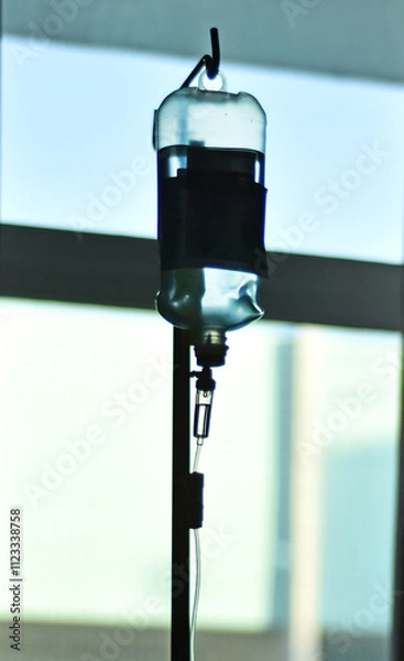 Fototapeta intravenous fluid for treat patient in the hospital. Closeup of saline bag. Saline water drop machine for infusion for treatment patient in hospital room.