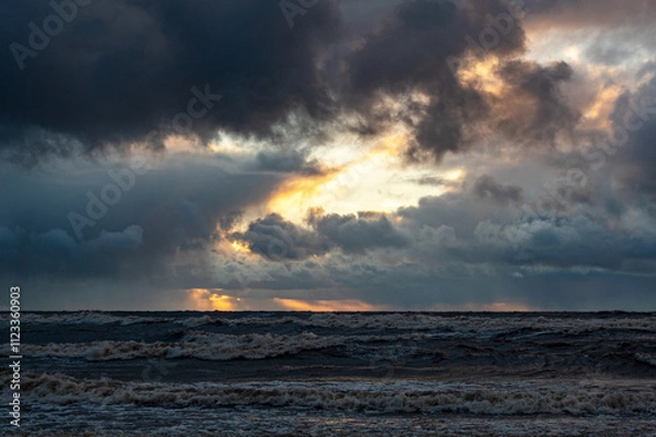 Fototapeta dramatic storm in the Baltic Sea, large waves crashing against the shore, blurred, unclear contours, rocky shore of Vidzeme