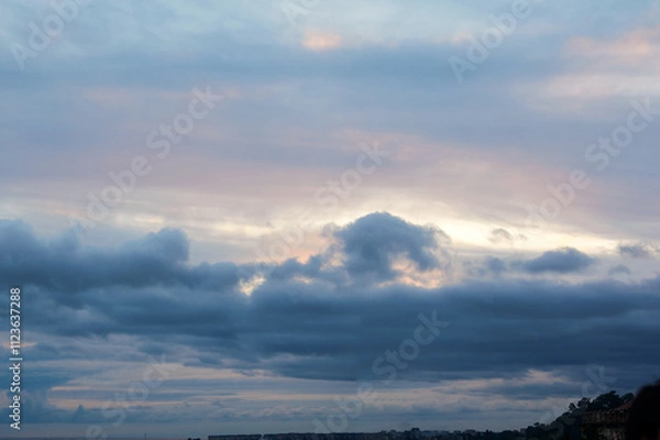 Obraz Sunset, Sky clouds over sea in the Evening with Orange, Yellow Gold sunlight in Golden hour and Dramatic fluffy, Horizon sea Summer sky landscape, Dusk sky background