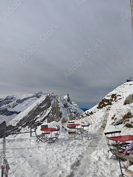 Fototapeta Snowy Swiss alps mountains during a cloudy autumn day