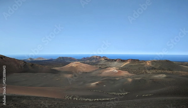 Fototapeta Volcanic landscape in the Timanfaya National Park on Lanzarote Spain Europe with a view over various hills and sea in the background