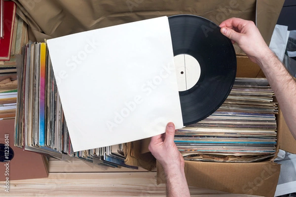 Fototapeta Browsing through vinyl records collection. Music background. Copy space. Retro styled image