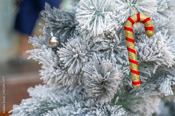 Fototapeta Christmas tree decorated with red and white stars and balls. Selective focus.