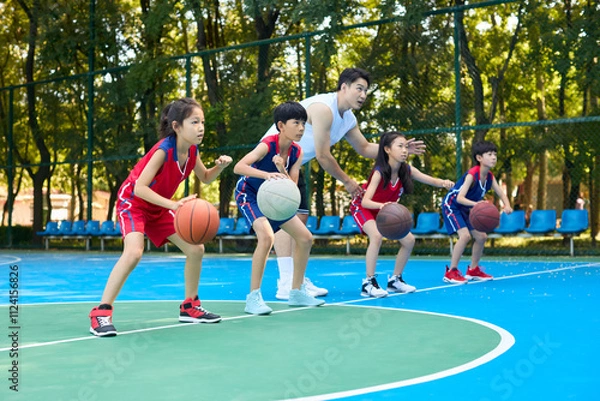 Obraz Chinese Kids Warming Up During Basketball Training Class