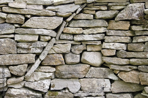 Fototapeta Curved circular texture pattern in a dry stone wall