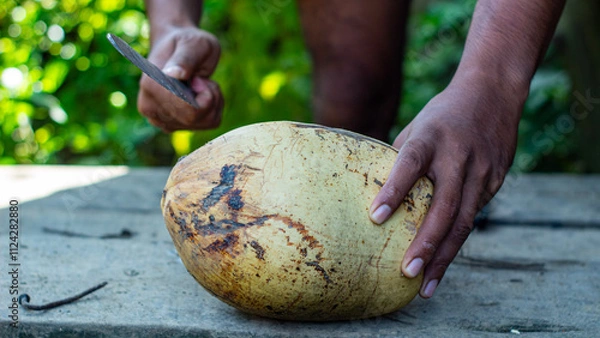 Obraz Man Cutting a Coconut