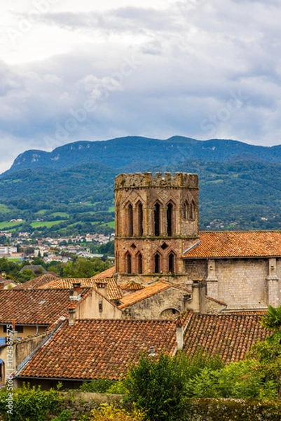 Fototapeta Red brick bell tower of Saint-Lizier Cathedral against the backdrop of the Ariège mountains