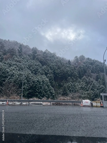 Fototapeta A winter road covered with snow, covered with frost, white snow