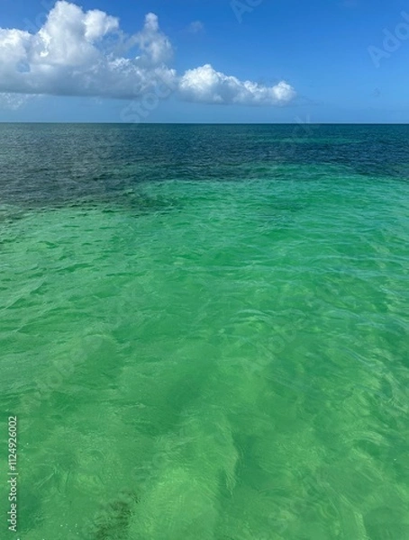 Fototapeta Concrete breakwater on the beach with a red heart painted on it