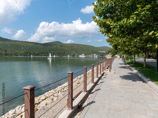 Fototapeta Abrau Durso, Russia 28 August 2024: Picturesque view of embankment of lake Abrau on sunny day in Abrau Durso