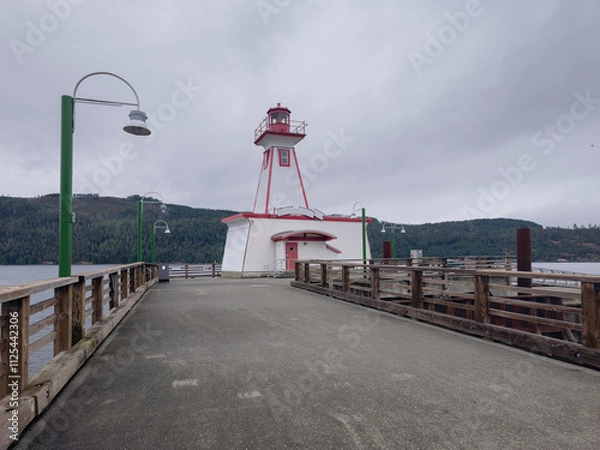 Fototapeta View of a Lighthouse on a duck during a cloudy day, historic site Port Alberni Lighthouse in Port Alberni