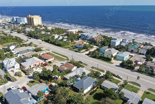 Obraz Aerial looking east over New Smyrna Beach, Florida neighborhoods, beachfront houses and the Atlantic Ocean.