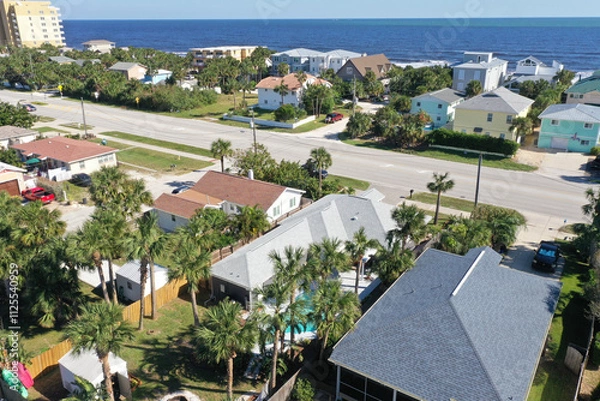 Obraz Aerial looking east over New Smyrna Beach, Florida neighborhoods, beachfront houses and the Atlantic Ocean.
