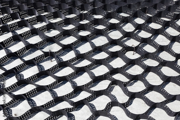 Fototapeta Polymer geogrid for filled with soil. Strengthening of sandy slopes with a geogrid