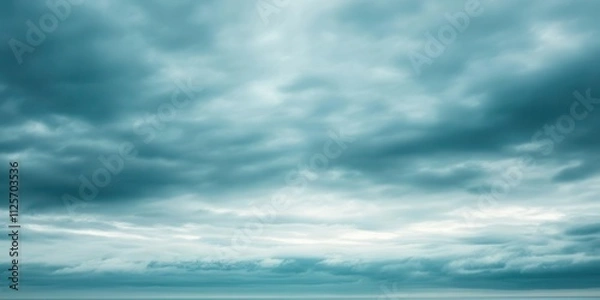 Fototapeta A serene view of a cloudy sky over a calm sea, evoking tranquility and contemplation.