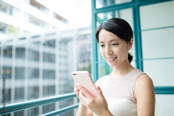 Obraz Woman looking at mobile phone
